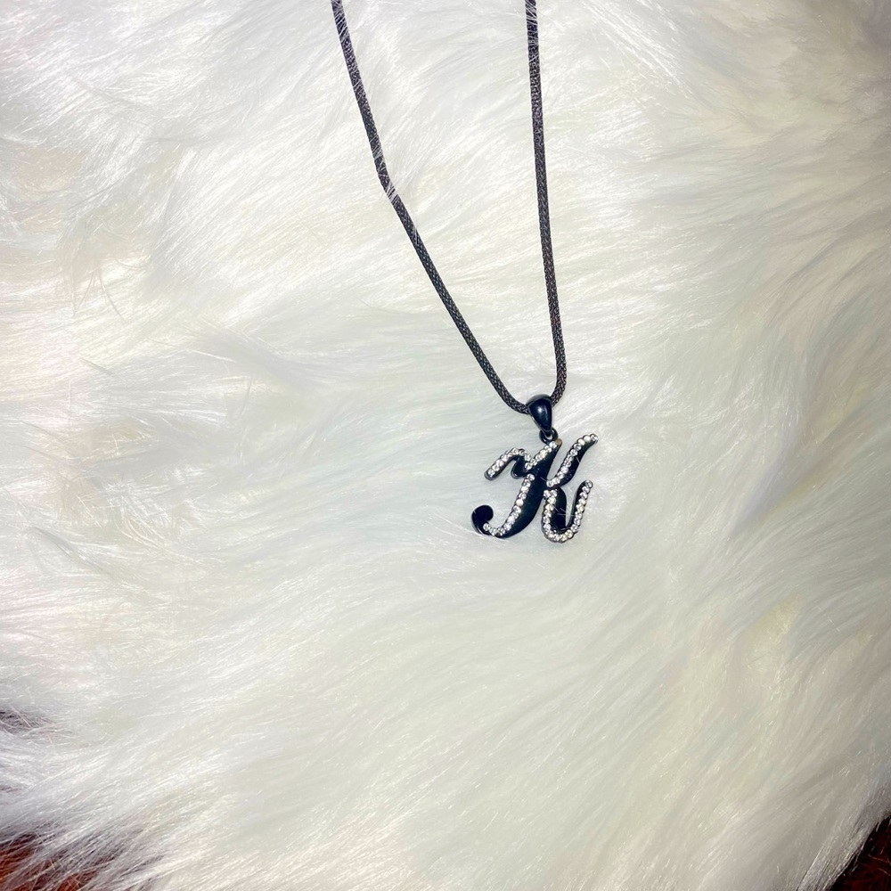 Necklace letter K in cursive writing black with‎ rhinestones on a black chain